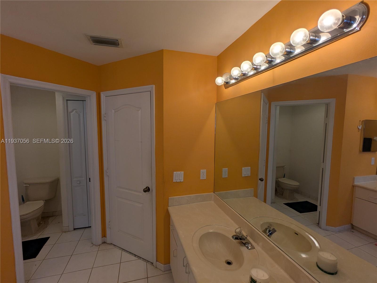12641 Southwest 28th Street Miramar, FL 33027 - Photo 25 of 61 a bathroom with a sink a toilet and shower
