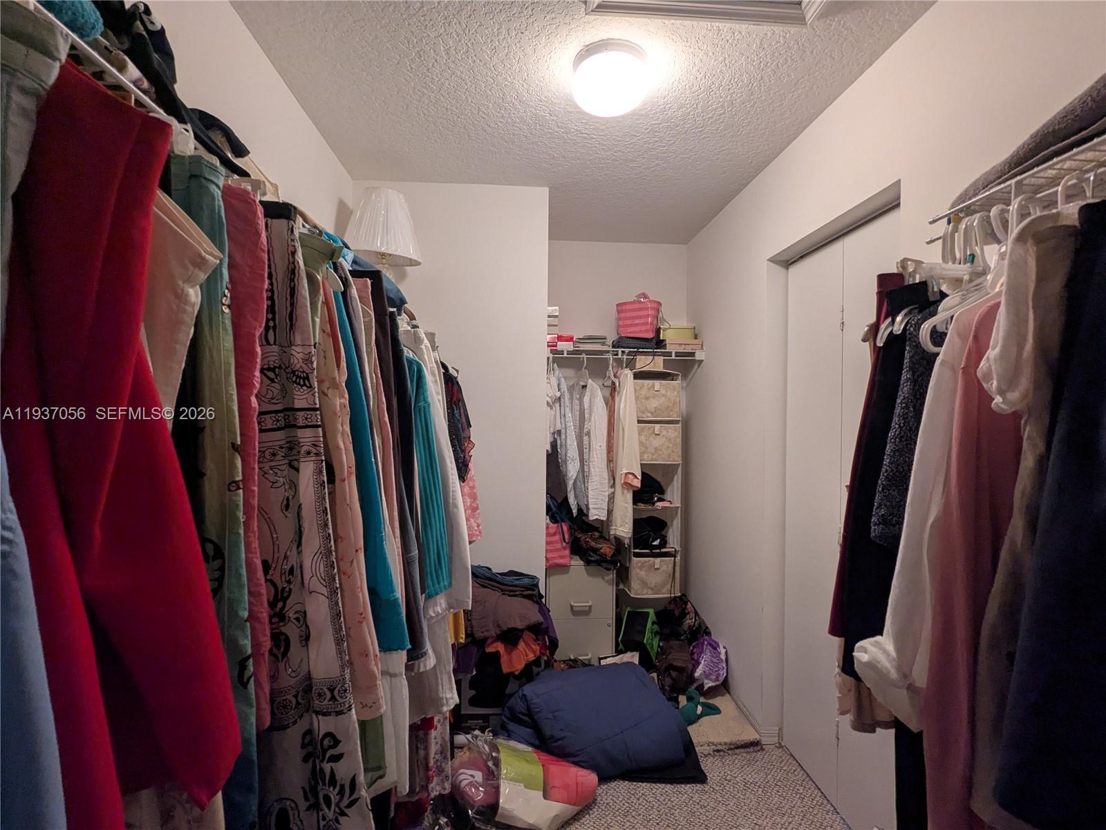 12641 Southwest 28th Street Miramar, FL 33027 - Photo 26 of 61 a view of walk in closet with clothes and shoes