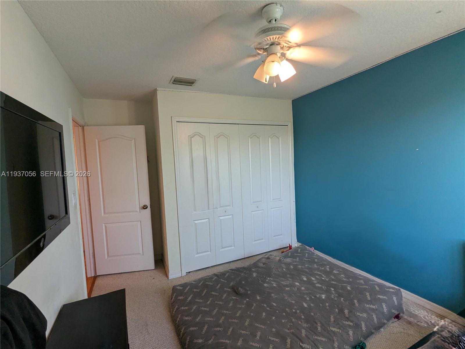 12641 Southwest 28th Street Miramar, FL 33027 - Photo 28 of 61 a view of a livingroom with a chandelier fan and windows