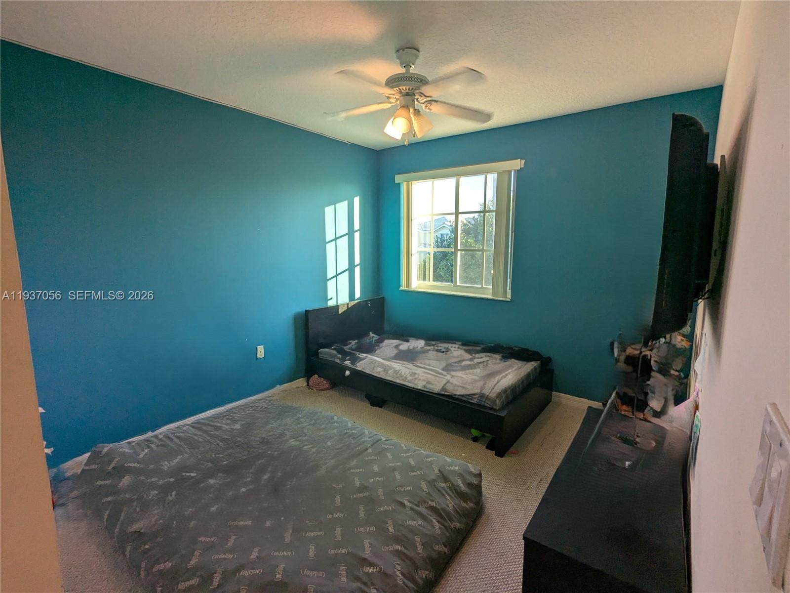 12641 Southwest 28th Street Miramar, FL 33027 - Photo 29 of 61 a bedroom with a bed dresser and a window