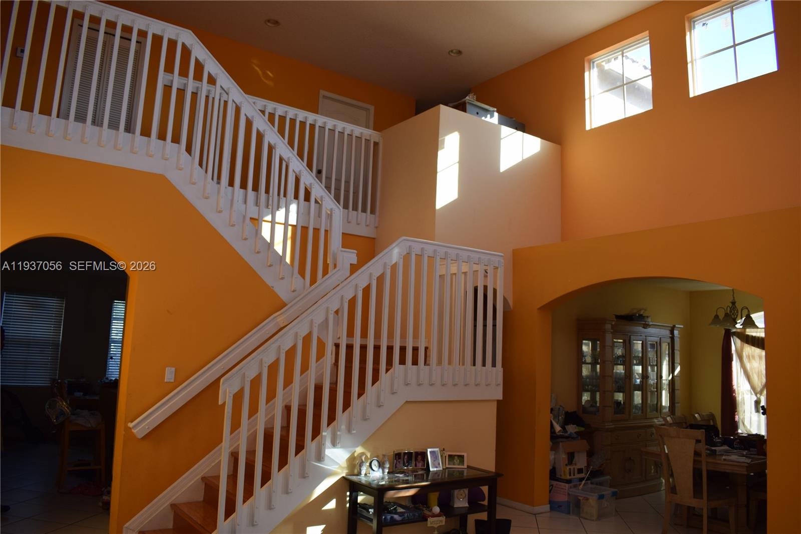12641 Southwest 28th Street Miramar, FL 33027 - Photo 36 of 61 a view of staircase with railing and a chandelier