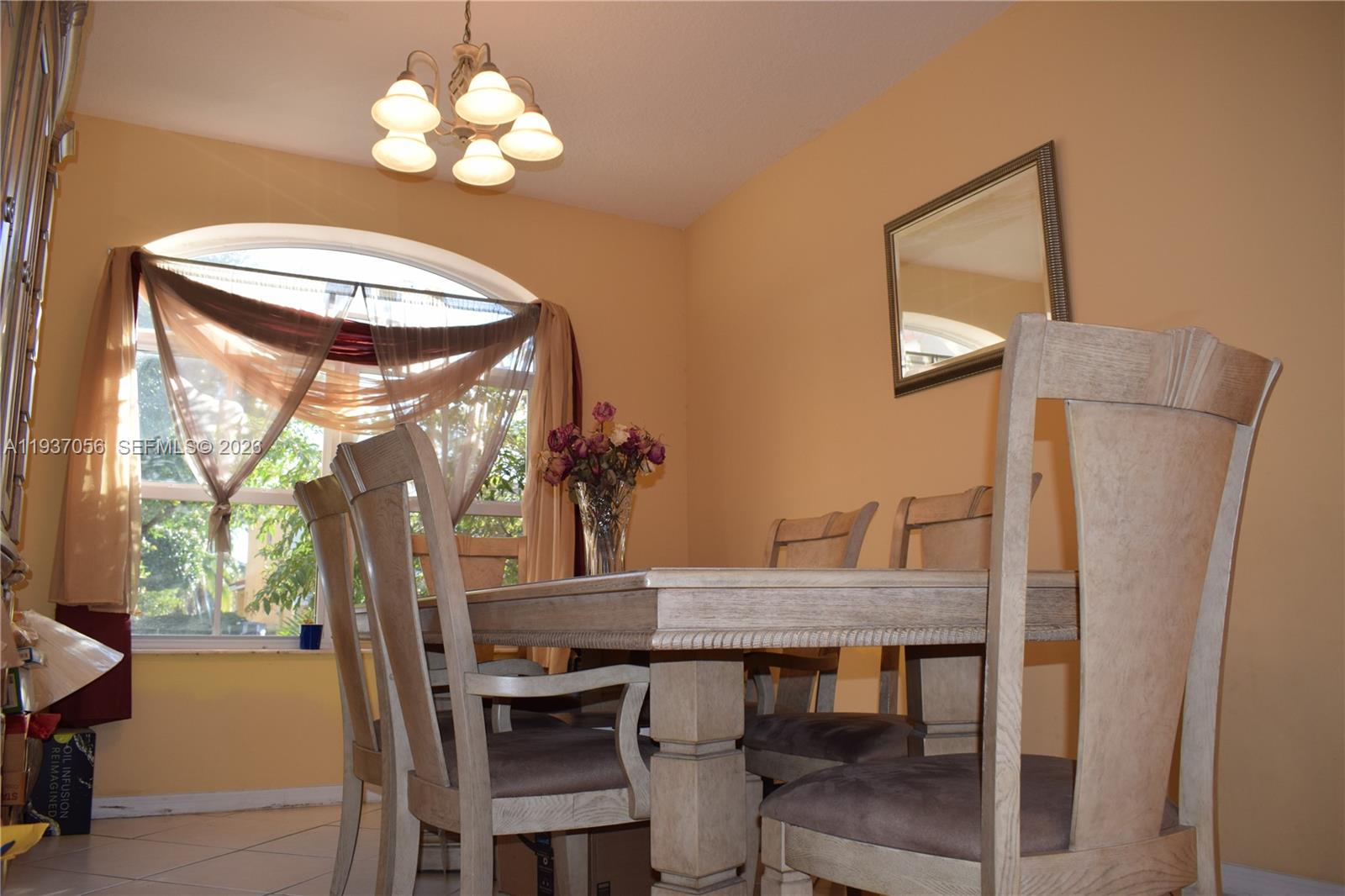 12641 Southwest 28th Street Miramar, FL 33027 - Photo 38 of 61 a view of a dining room with furniture a chandelier and wooden floor