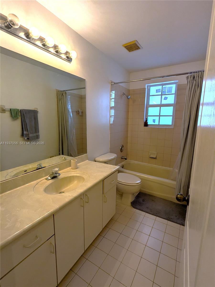 12641 Southwest 28th Street Miramar, FL 33027 - Photo 43 of 61 a bathroom with a granite countertop sink a toilet and mirror