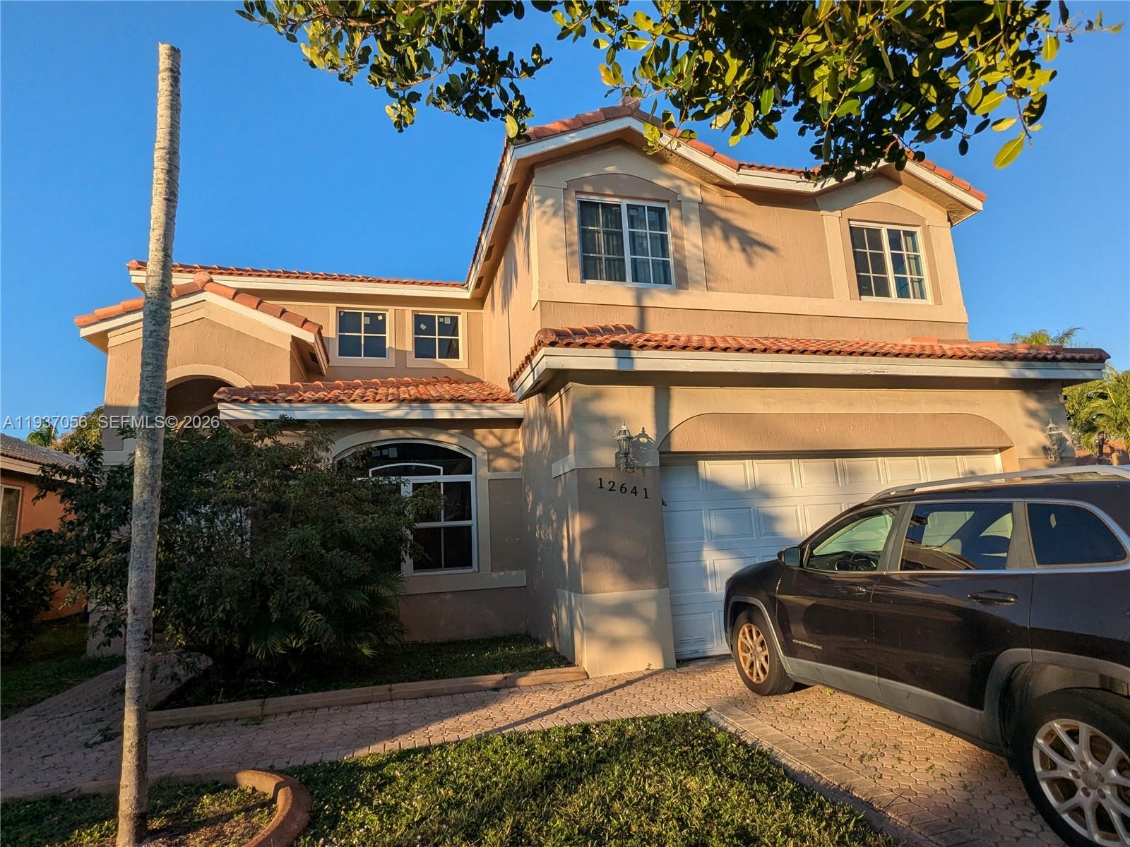 12641 Southwest 28th Street Miramar, FL 33027 - Photo 45 of 61 a front view of a house with a yard