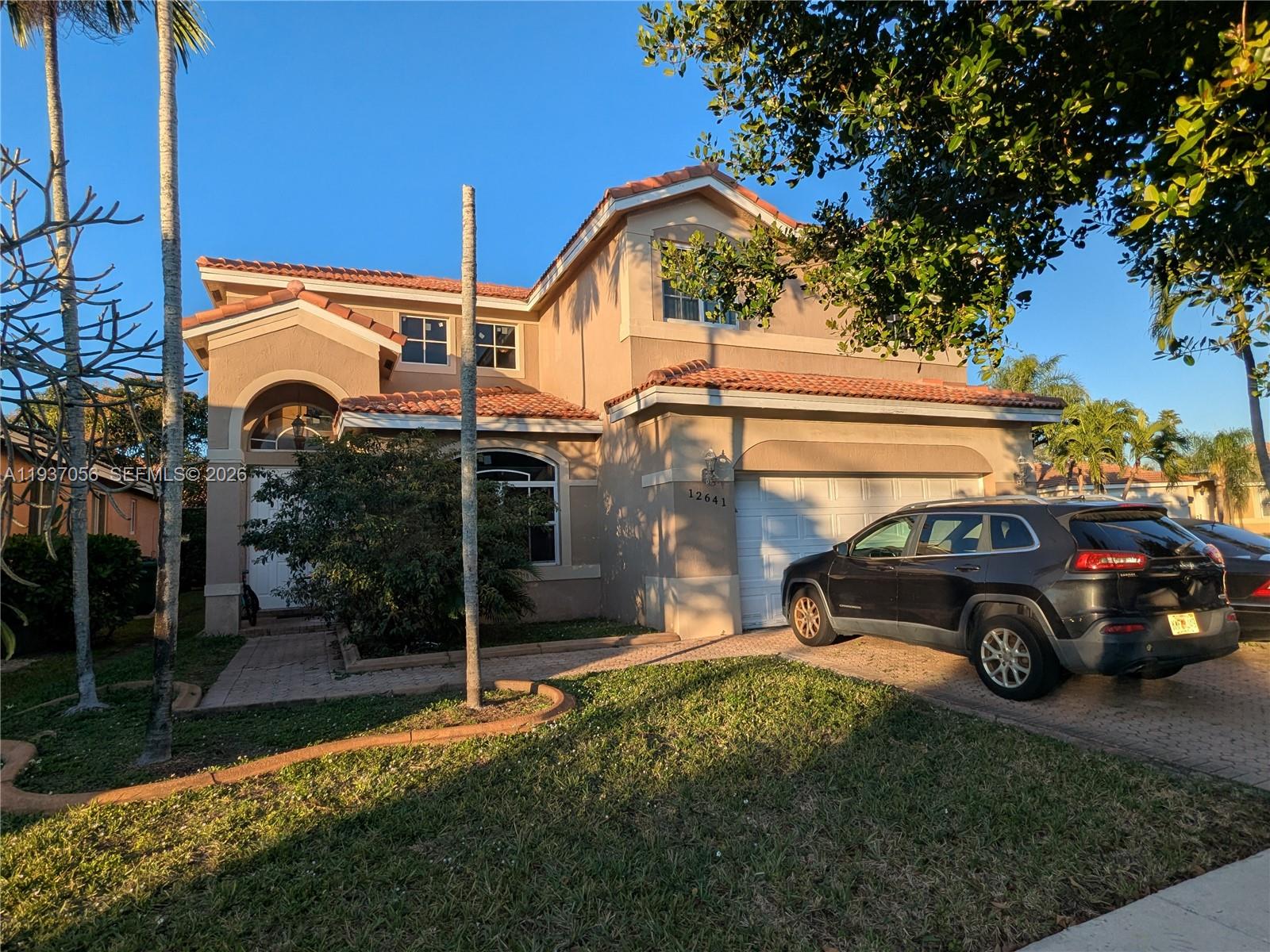 12641 Southwest 28th Street Miramar, FL 33027 - Photo 46 of 61 a view of a car park in front of a house