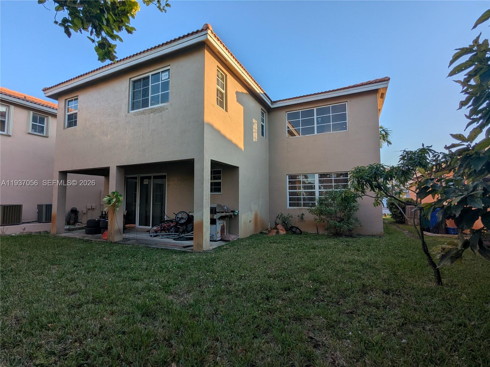 12641 Southwest 28th Street Miramar, FL 33027 - Photo 49 of 61 a front view of a house with a yard and porch