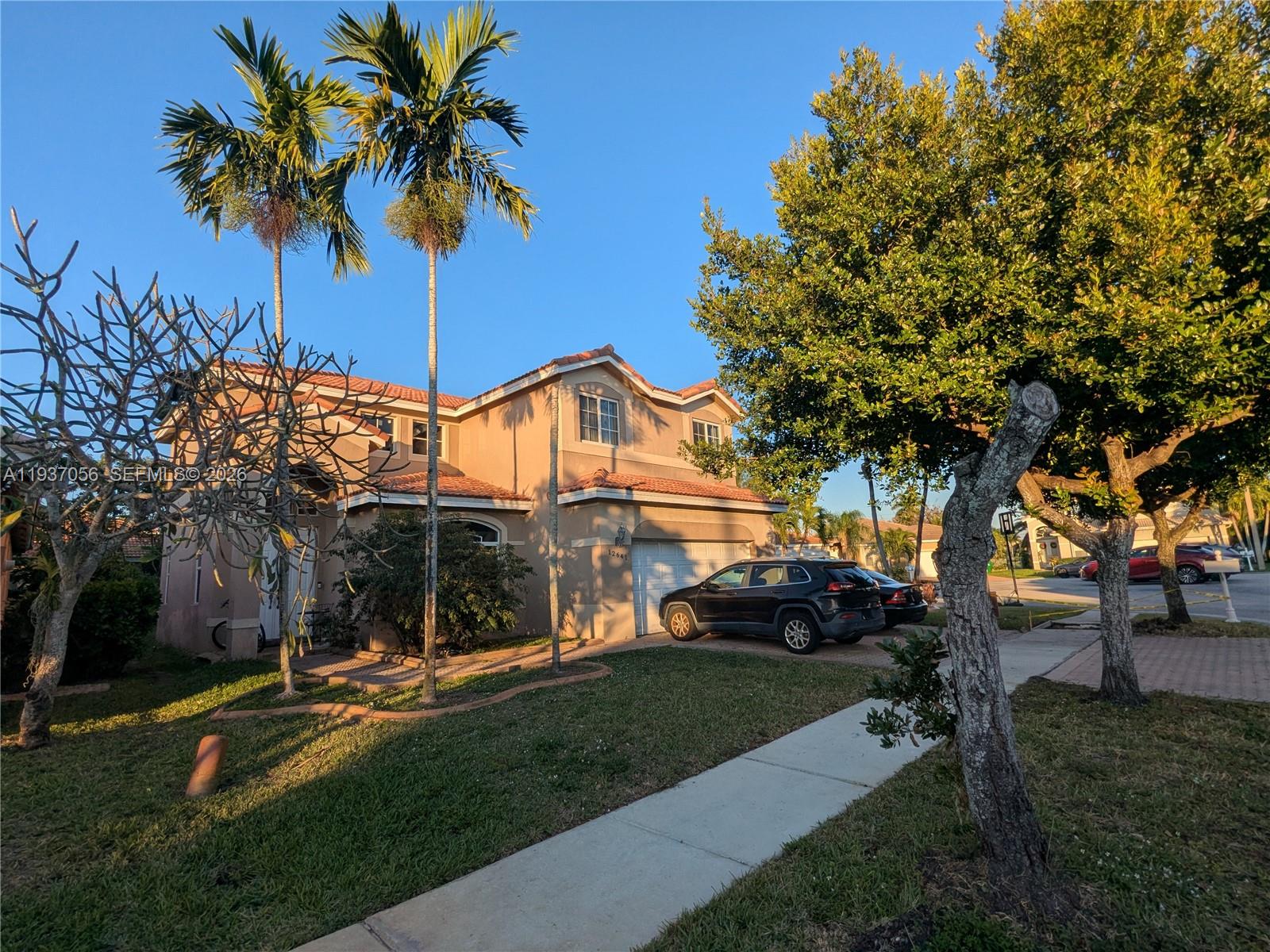 12641 Southwest 28th Street Miramar, FL 33027 - Photo 55 of 61 a front view of a house with garden