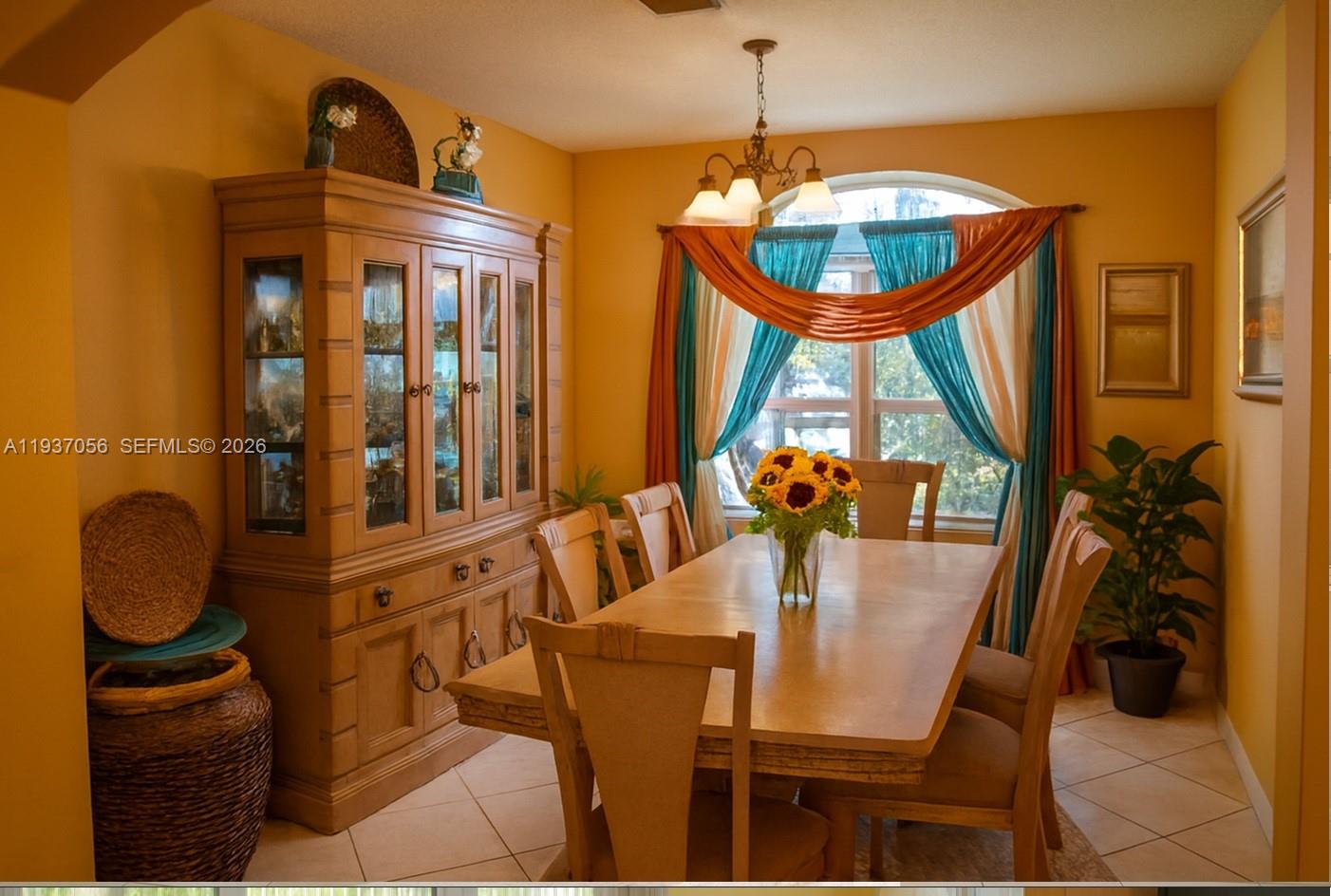 12641 Southwest 28th Street Miramar, FL 33027 - Photo 6 of 61 a view of a dining room with furniture and chandelier