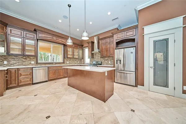a large kitchen with stainless steel appliances kitchen island granite countertop a stove a sink a counter space and a window