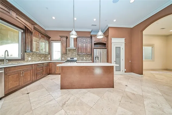 a kitchen with stainless steel appliances granite countertop a stove and a microwave