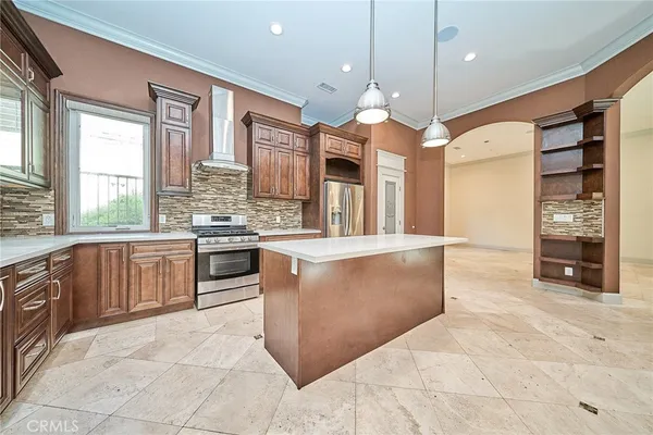 a kitchen with stainless steel appliances granite countertop a stove and a refrigerator