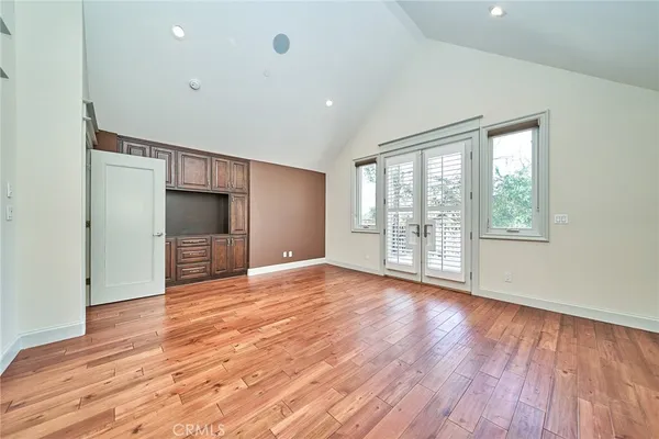 a view of a room with wooden floor