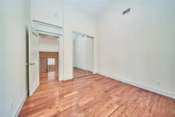 a view of a room with wooden floor and white walls