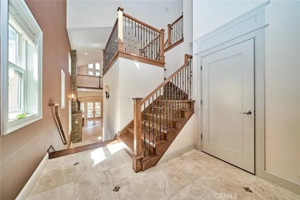 a view of a hallway with wooden floor and entryway