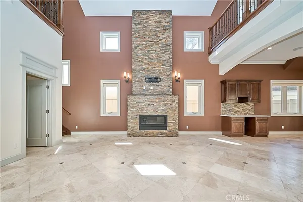 a view of a livingroom with an empty space and a fireplace
