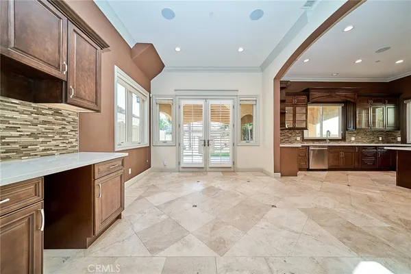 a large kitchen with stainless steel appliances kitchen island granite countertop a refrigerator a oven a sink and dishwasher