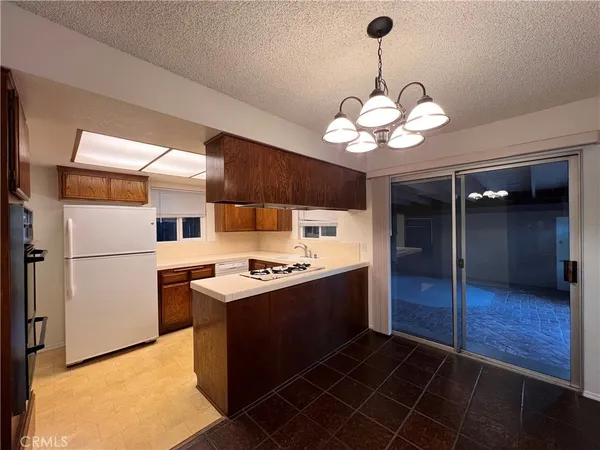 a kitchen with cabinets a stove and a refrigerator
