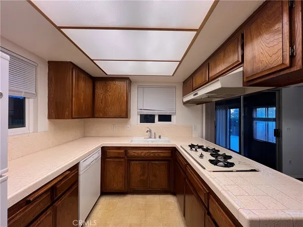 a kitchen with stainless steel appliances a stove sink and cabinets