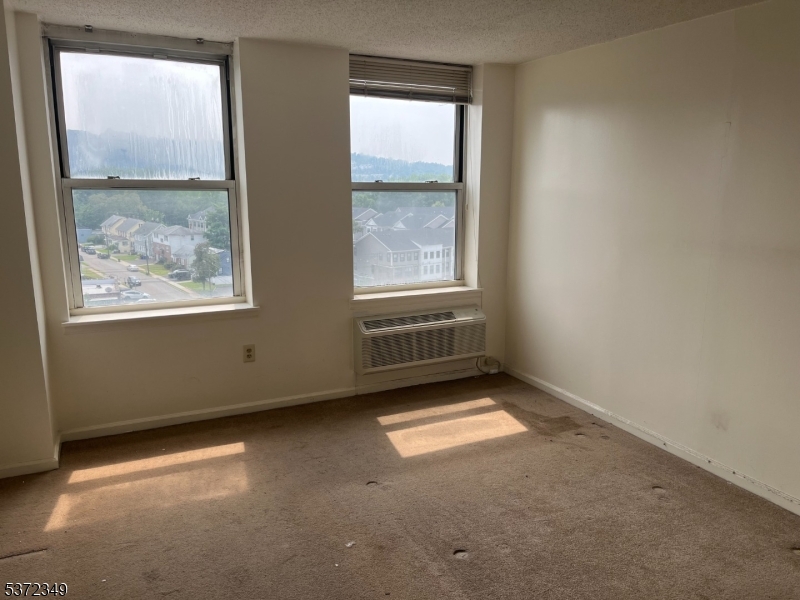 300 Main Street, Unit 901 Little Falls, NJ 07424 - Photo 3 of 15 an empty room with windows