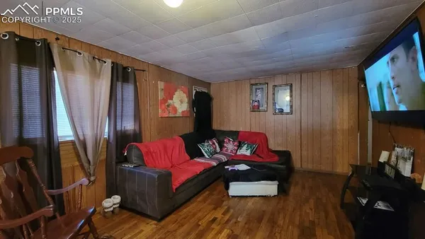 a living room with furniture rug and wooden floor