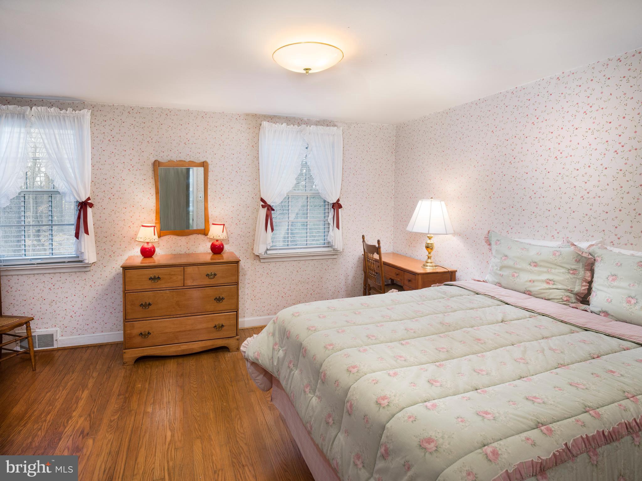 34 Ridgewood Road Wayne, PA 19087 - Photo 21 of 28 a bedroom with a bed and wooden floor