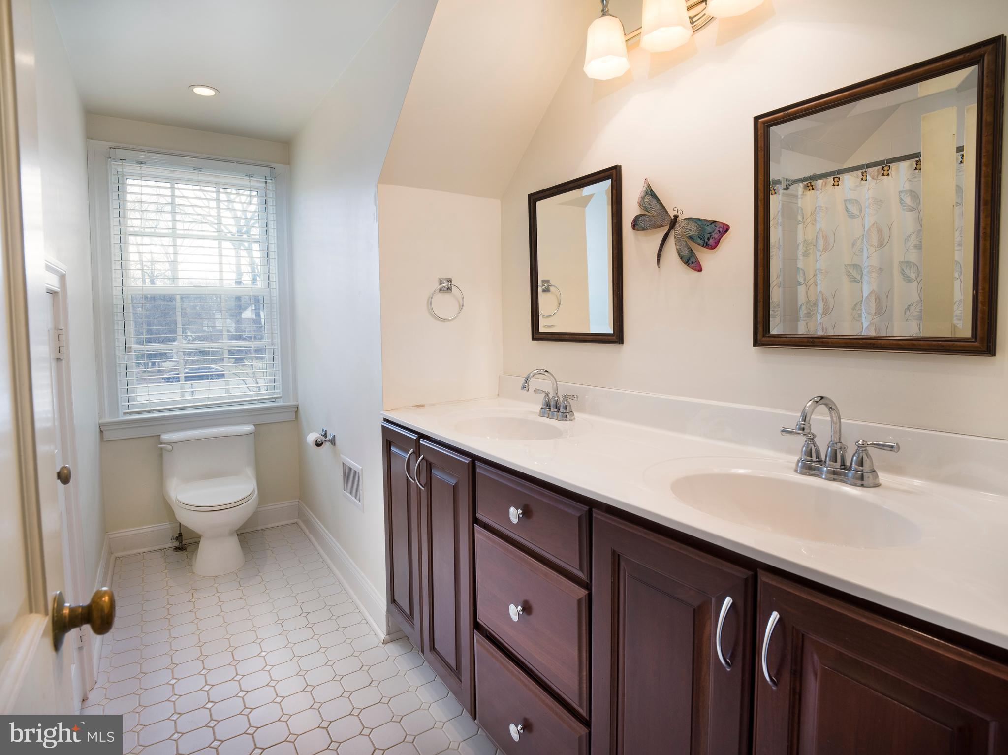 34 Ridgewood Road Wayne, PA 19087 - Photo 22 of 28 a spacious bathroom with a toilet sink and mirror
