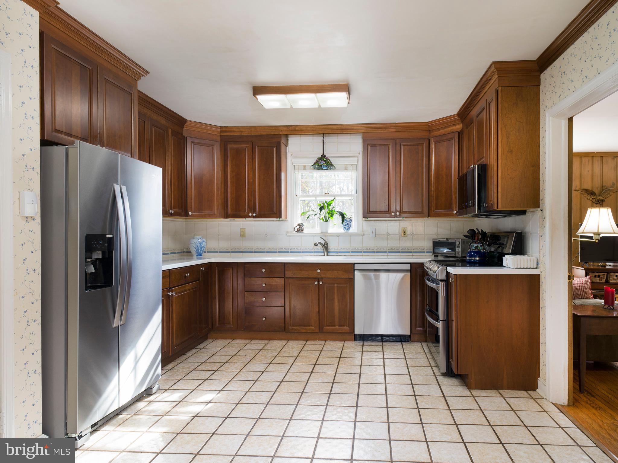 34 Ridgewood Road Wayne, PA 19087 - Photo 8 of 28 a kitchen with stainless steel appliances granite countertop a refrigerator and a sink