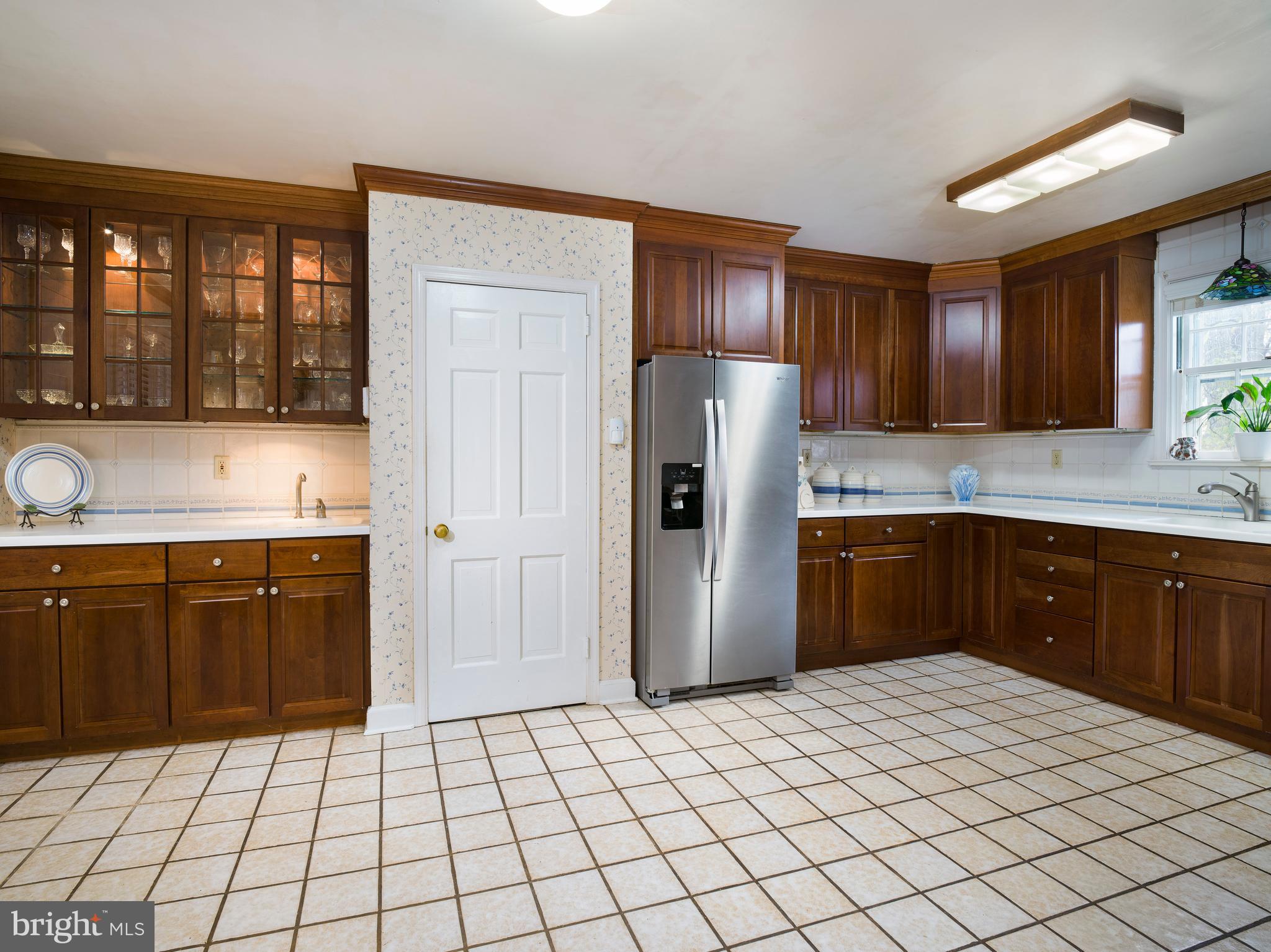 34 Ridgewood Road Wayne, PA 19087 - Photo 9 of 28 a kitchen with a refrigerator sink and cabinets