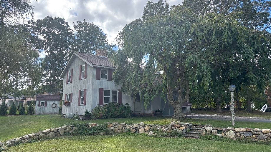 a front view of a house with a garden