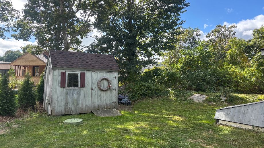 76 Norton Orchard Road Edgartown, MA 02539 - Photo 3 of 7 a backyard of a house with table and chairs