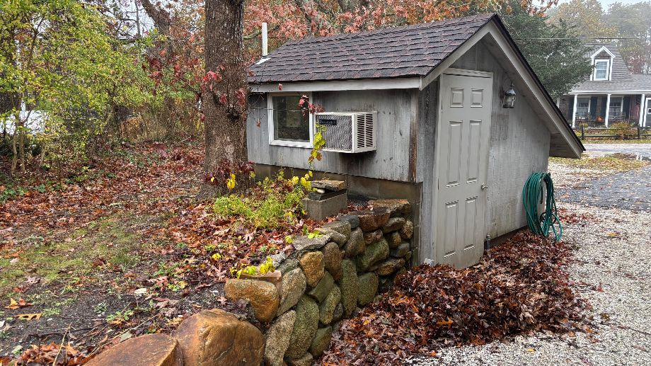 76 Norton Orchard Road Edgartown, MA 02539 - Photo 7 of 7 a front view of a house with a garden