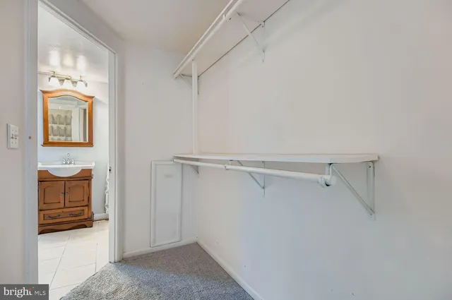 a view of walk in closet with empty racks