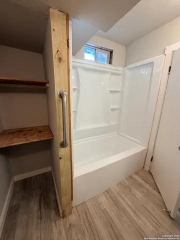 a bathroom with a bathtub and shower