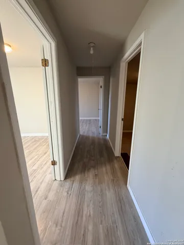 a view of a hallway view with wooden floor and staircase
