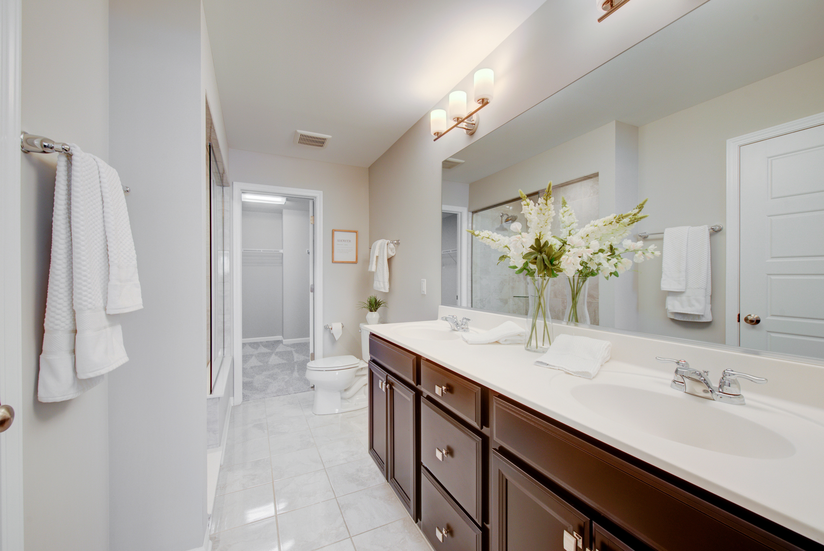 980 Station Boulevard Aurora, IL 60504 - Photo 13 of 27 a bathroom with a double vanity sink and a mirror
