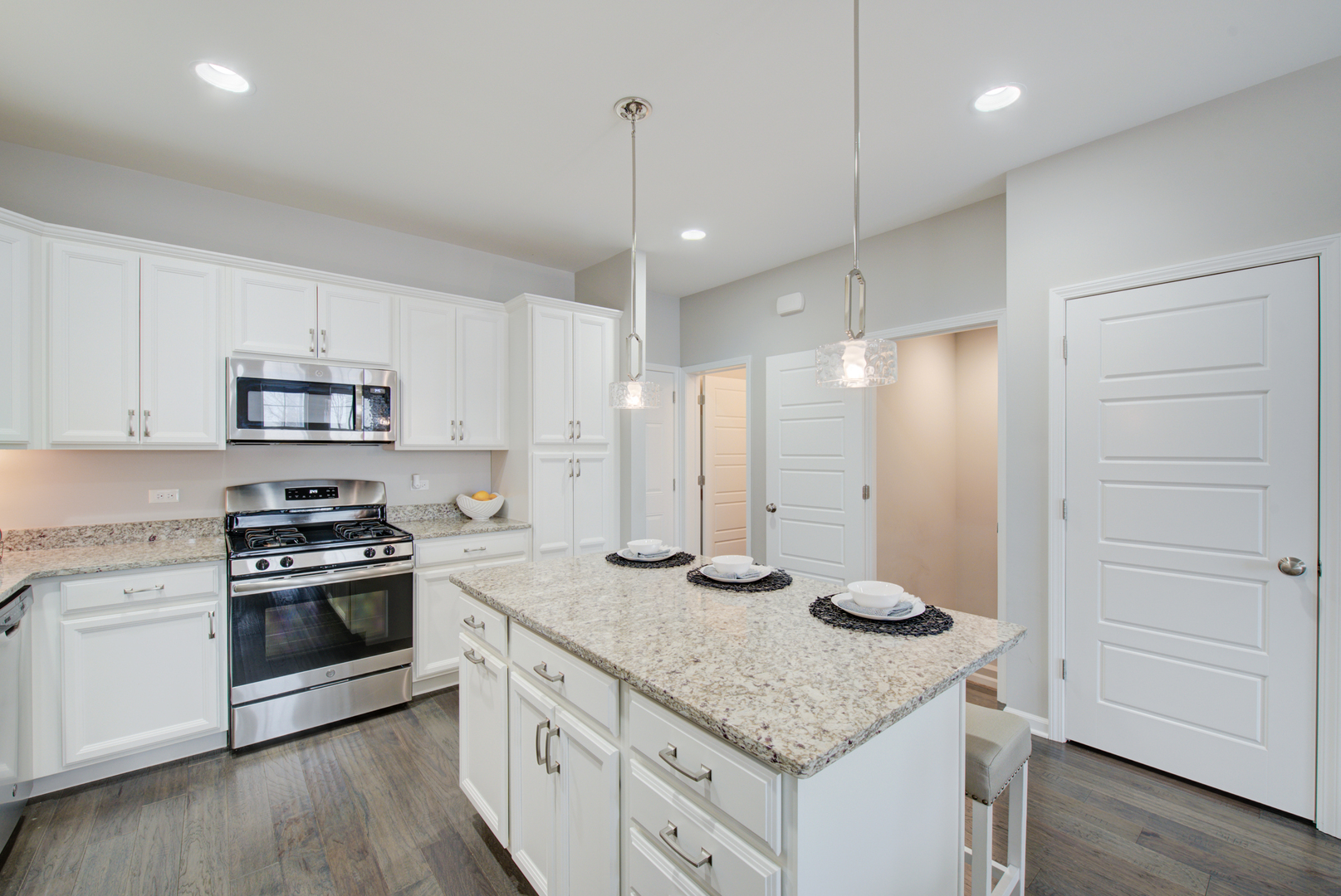 980 Station Boulevard Aurora, IL 60504 - Photo 8 of 27 a kitchen with granite countertop stainless steel appliances and wooden cabinets