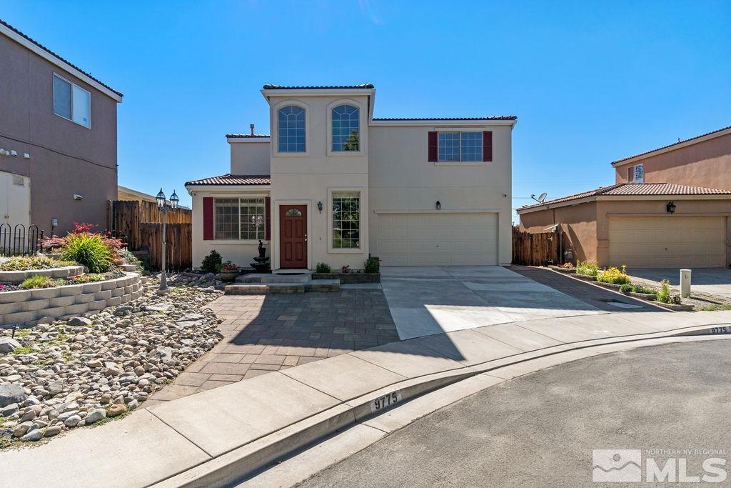 9775 Meadowstar Drive Reno, NV 89506 - Photo 1 of 30 a front view of a house with garden