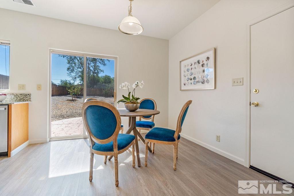 9775 Meadowstar Drive Reno, NV 89506 - Photo 11 of 30 a view of a dining room with furniture and wooden floor