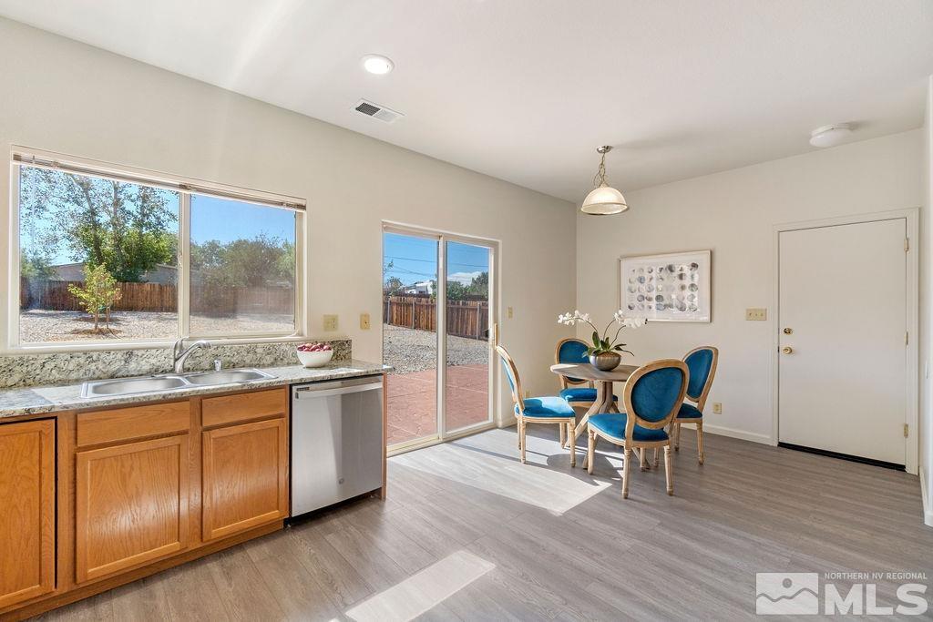 9775 Meadowstar Drive Reno, NV 89506 - Photo 18 of 30 a living room with granite countertop furniture a fireplace and a floor to ceiling window