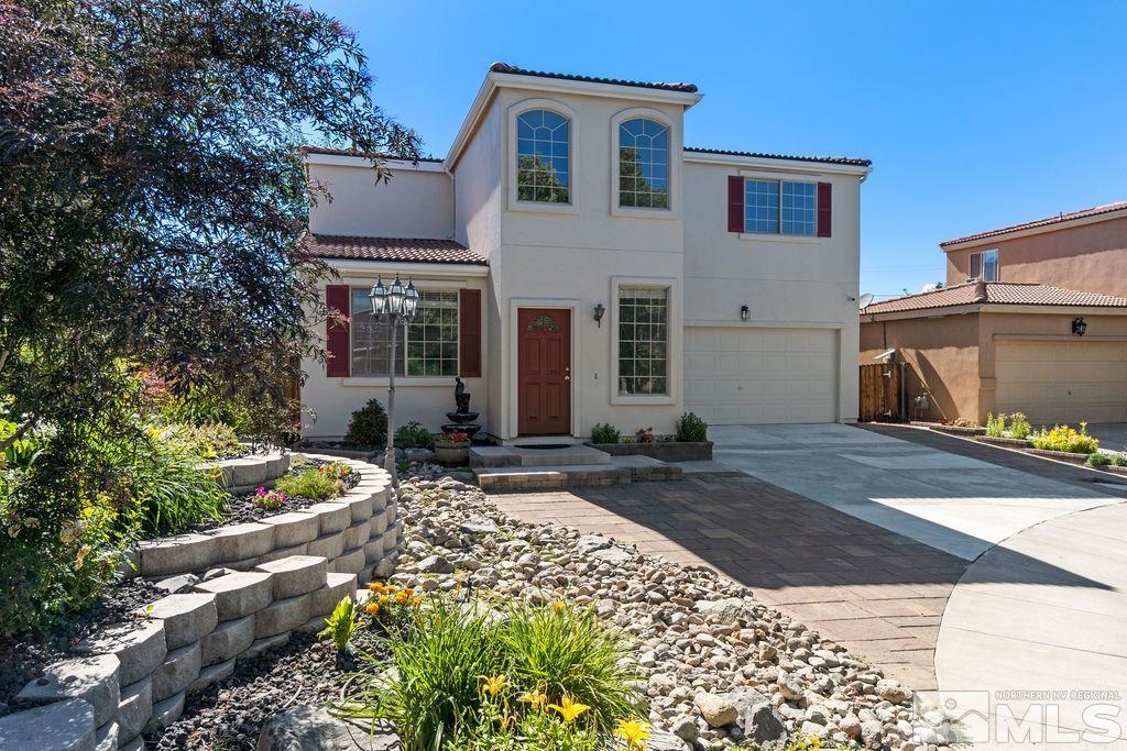 9775 Meadowstar Drive Reno, NV 89506 - Photo 2 of 30 a front view of a house with garden