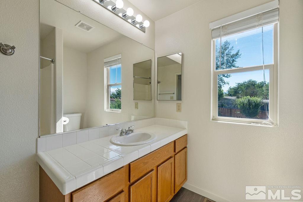 9775 Meadowstar Drive Reno, NV 89506 - Photo 23 of 30 a bathroom with a sink and a mirror
