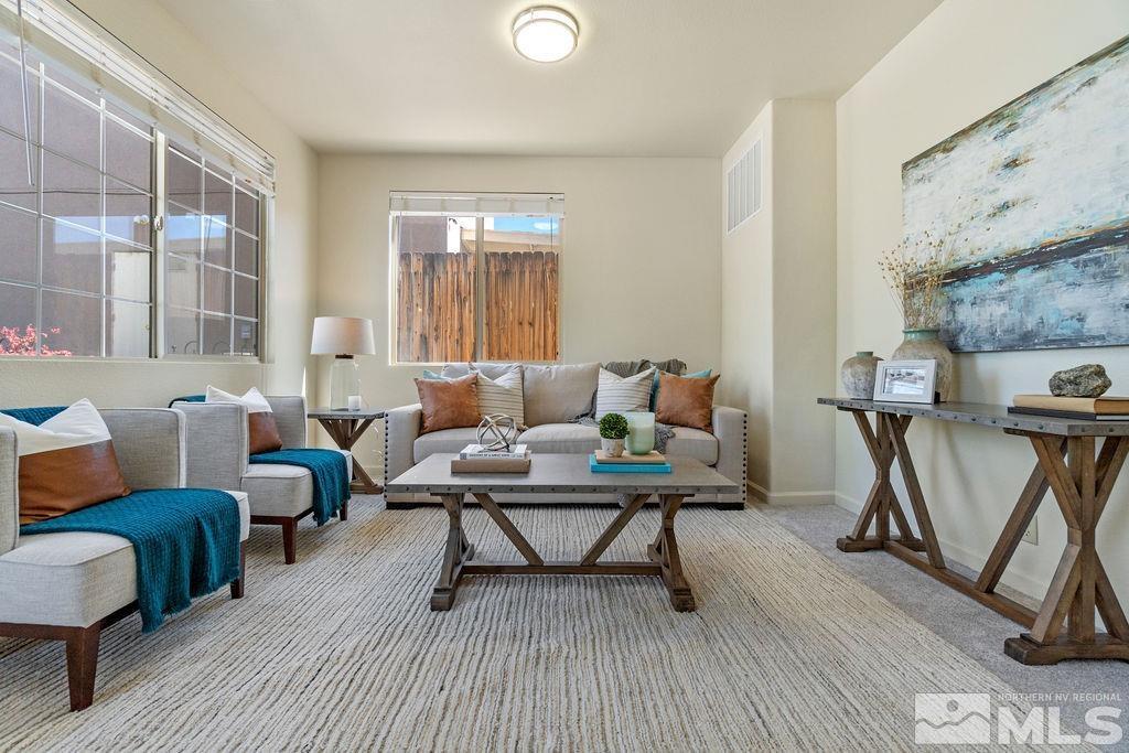 9775 Meadowstar Drive Reno, NV 89506 - Photo 5 of 30 a living room with furniture a flat screen tv and a table