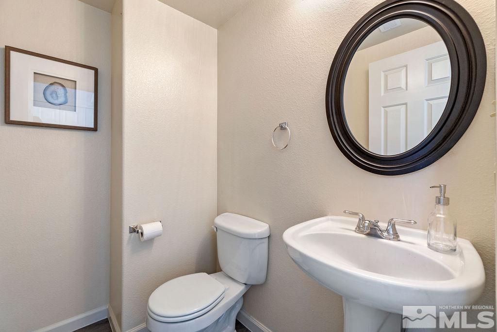 9775 Meadowstar Drive Reno, NV 89506 - Photo 9 of 30 a bathroom with a sink a mirror and a toilet