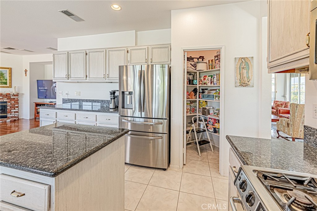 5423 Canmore Court Riverside, CA 92507 - Photo 17 of 58 a kitchen with stainless steel appliances granite countertop a sink stove and refrigerator