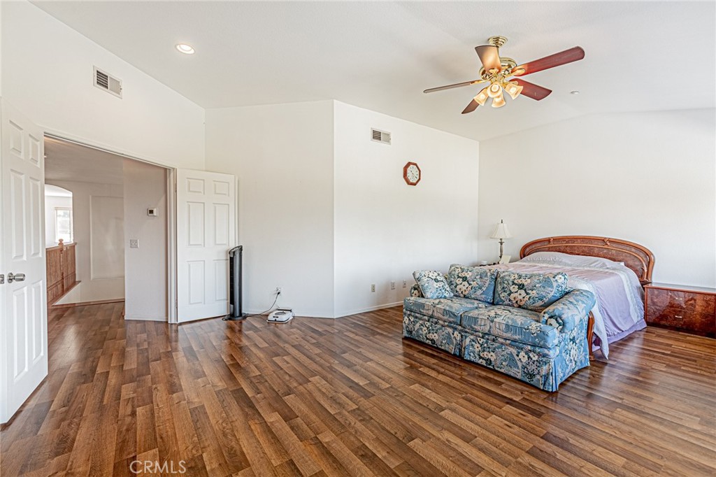 5423 Canmore Court Riverside, CA 92507 - Photo 23 of 58 a bedroom with a bed and a chandelier