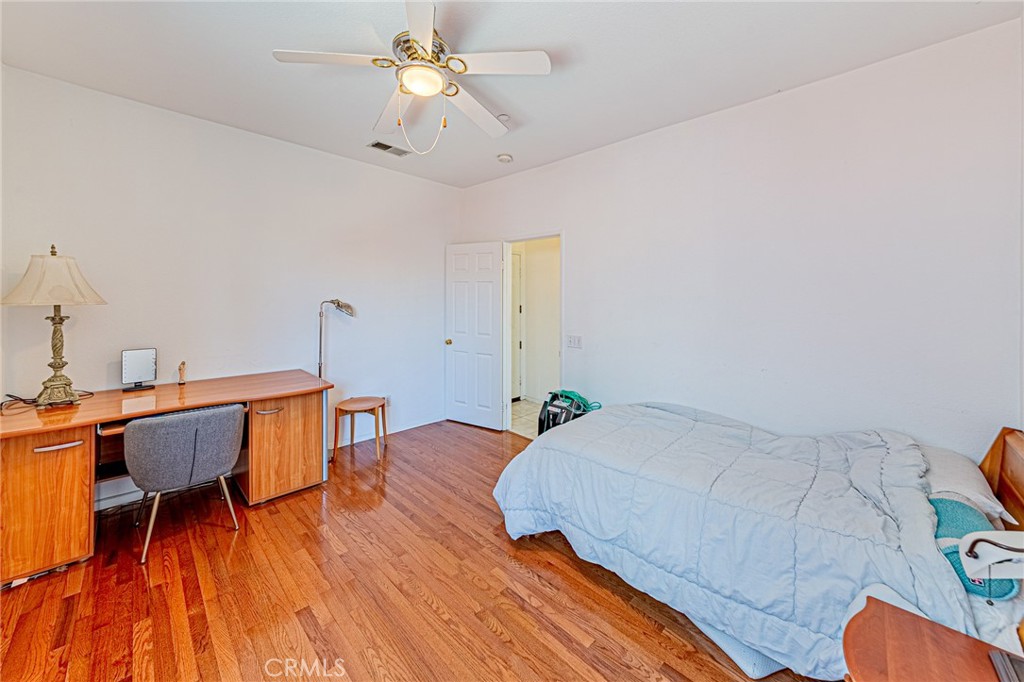 5423 Canmore Court Riverside, CA 92507 - Photo 27 of 58 a bedroom with a bed and a chandelier