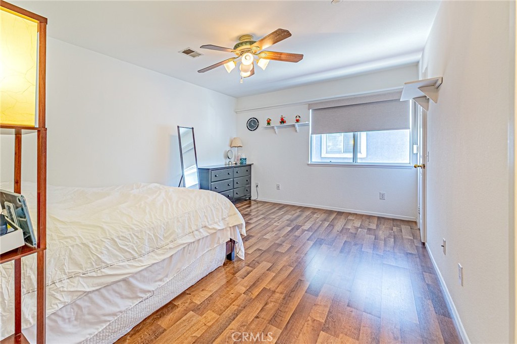 5423 Canmore Court Riverside, CA 92507 - Photo 32 of 58 a bedroom with a bed and a chandelier