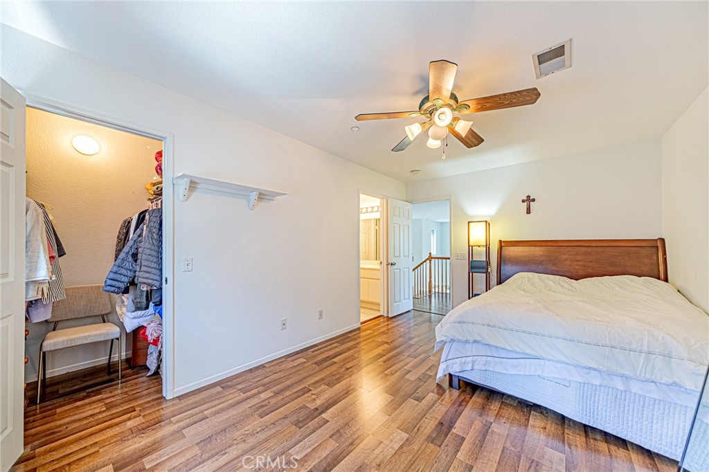 5423 Canmore Court Riverside, CA 92507 - Photo 33 of 58 a bedroom with a bed and a chandelier