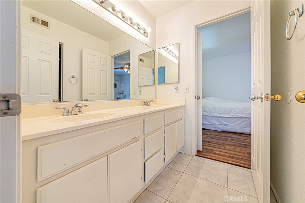 5423 Canmore Court Riverside, CA 92507 - Photo 34 of 58 a bathroom with a sink a vanity and a mirror