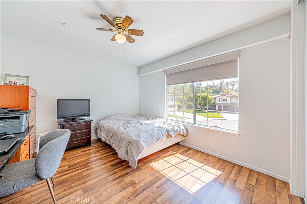 5423 Canmore Court Riverside, CA 92507 - Photo 38 of 58 a bedroom with a bed and wooden floor